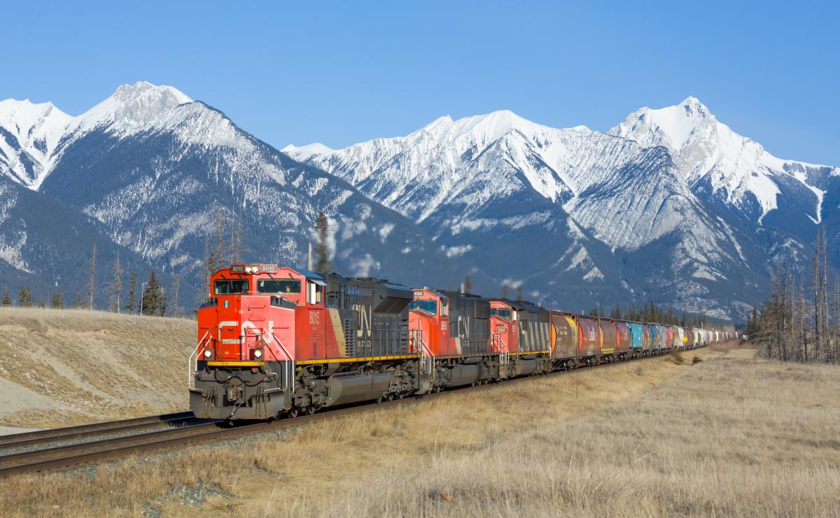 Red train with a mountain range in the background